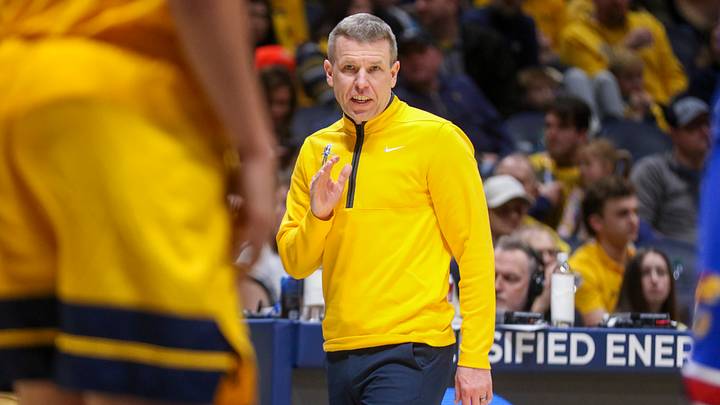 Jan 10, 2026; Morgantown, West Virginia, USA; West Virginia Mountaineers head coach Ross Hodge talks to a player during the first half against the Kansas Jayhawks at Hope Coliseum. Mandatory Credit: Ben Queen-Imagn Images Jan 10, 2026; Morgantown, West Virginia, USA; West Virginia Mountaineers head coach Ross Hodge talks to a player during the first half against the Kansas Jayhawks at Hope Coliseum. Mandatory Credit: Ben Queen-Imagn Images