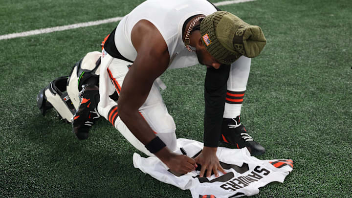 Nov 9, 2025; East Rutherford, New Jersey, USA; Cleveland Browns quarterback Shedeur Sanders (12) signs his jersey on the field after the game against the New York Jets at MetLife Stadium. Mandatory Credit: Vincent Carchietta-Imagn Images