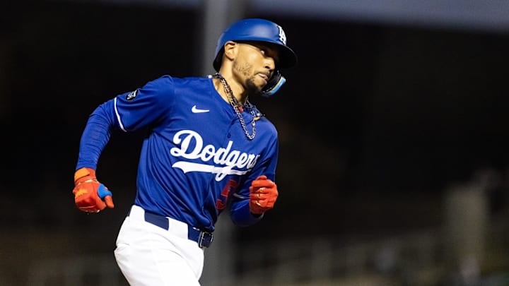 Mar 4, 2025; Phoenix, Arizona, USA; Los Angeles Dodgers shortstop Mookie Betts (50) rounds the bases after hitting a home run against the Cincinnati Reds during a spring training game at Camelback Ranch-Glendale. Mandatory Credit: Mark J. Rebilas-Imagn Images