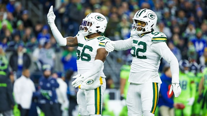 Dec 15, 2024; Seattle, Washington, USA; Green Bay Packers linebacker Edgerrin Cooper (56) celebrates with defensive end Rashan Gary (52) following a sack against the Seattle Seahawks during the first quarter at Lumen Field.