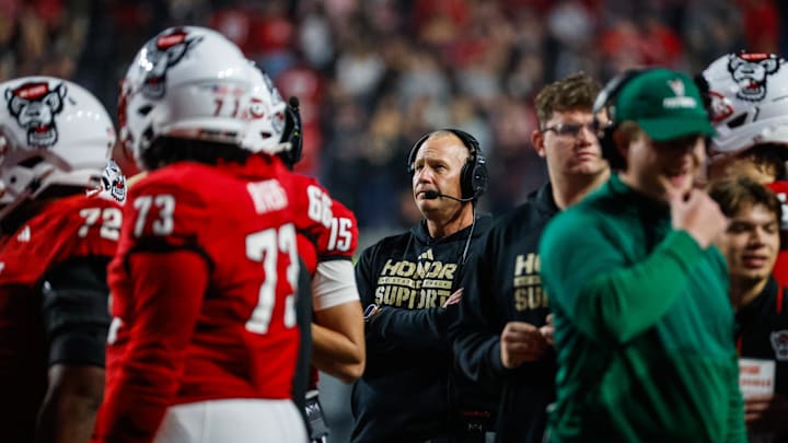 Nov 21, 2025; Raleigh, North Carolina, USA;  NC State Wolfpack head coach Dave Doeren looks on during the second half of the game against Florida State Seminoles at Carter-Finley Stadium. Mandatory Credit: Jaylynn Nash-Imagn Images