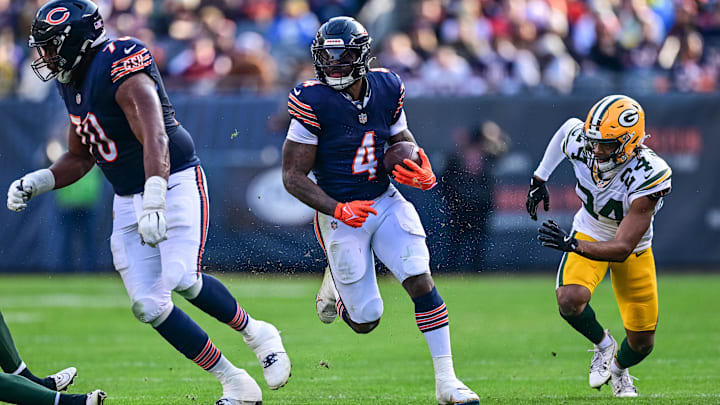 D'Andre Swift runs behind Braxton Jones looking for an opening against Green Bay. Swift suffered a groin injury in the game.