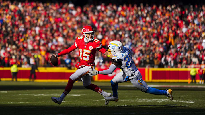 Dec 14, 2025; Kansas City, Missouri, USA; Kansas City Chiefs quarterback Patrick Mahomes (15) looks to pass under pressure from Los Angeles Chargers safety Tony Jefferson (23) during the second quarter at GEHA Field at Arrowhead Stadium. Mandatory Credit: Jay Biggerstaff-Imagn Images