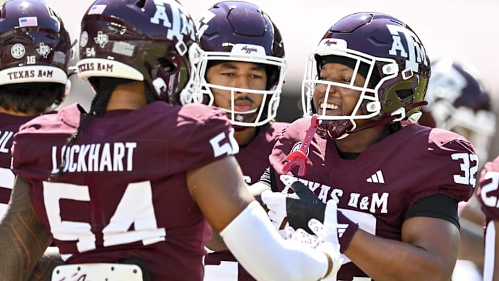 Sep 27, 2025; College Station, Texas, USA; Texas A&M Aggies linebacker Tristan Jernigan (32) greets offensive lineman Mark Nabou Jr. (54) during warm ups prior to the game against the Auburn Tigers at Kyle Field. Mandatory Credit: Maria Lysaker-Imagn Images 
