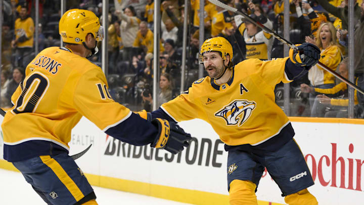 Mar 6, 2025; Nashville, Tennessee, USA;  Nashville Predators left wing Filip Forsberg (9) celebrates his goal with center Colton Sissons (10) against the Seattle Kraken during the first period at Bridgestone Arena. Mandatory Credit: Steve Roberts-Imagn Images