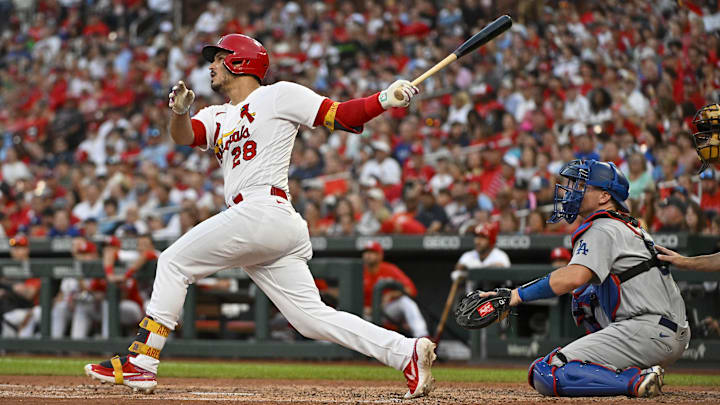 Jul 13, 2022; St. Louis, Missouri, USA;  St. Louis Cardinals third baseman Nolan Arenado (28) hits a two run home run against the Los Angeles Dodgers during the third inning at Busch Stadium. Mandatory Credit: Jeff Curry-Imagn Images