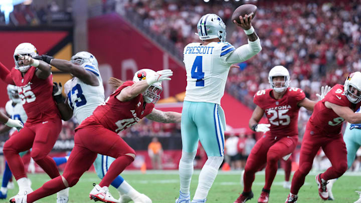 Dallas Cowboys quarterback Dak Prescott is hit by Arizona Cardinals linebacker Dennis Gardeck as he throws.