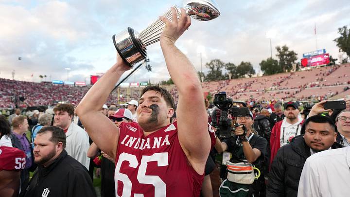 Jan 1, 2026; Pasadena, CA, USA; Indiana Hoosiers offensive lineman Carter Smith (65) celebrates with the trophy after defeating the Alabama Crimson Tide in the 2026 Rose Bowl and quarterfinal game of the College Football Playoff at Rose Bowl Stadium. Mandatory Credit: Kirby Lee-Imagn Images