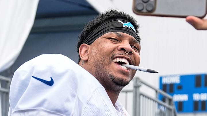 Detroit Lions defensive end Marcus Davenport (92) takes a selfie with fans after practice during training camp 