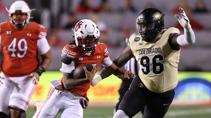 Oct 25, 2025; Salt Lake City, Utah, USA; Utah Utes quarterback Byrd Ficklin (15) runs against Colorado Buffaloes defensive lineman Jehiem Oatis (96) during the second quarter at Rice-Eccles Stadium. Mandatory Credit: Rob Gray-Imagn Images