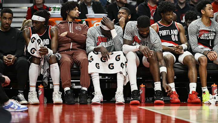 Mar 11, 2024; Portland, Oregon, USA; The Portland Trail Blazers bench, from left, guard Malcolm Brogdon (11), guard Shaedon Sharpe (17), center Duop Reath (26), center Deandre Ayton (2), guard Scoot Henderson (00), and guard Anfernee Simons (1) watch the final minutes of a game against the Boston Celtics at Moda Center. Mandatory Credit: Troy Wayrynen-USA TODAY Sports