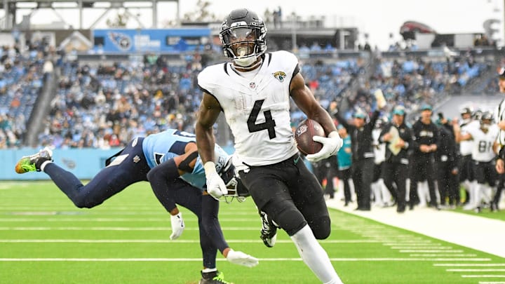 Dec 8, 2024; Nashville, Tennessee, USA;  Jacksonville Jaguars running back Tank Bigsby (4) runs the ball and scores a touchdown against the Tennessee Titans during the second half at Nissan Stadium. Mandatory Credit: Steve Roberts-Imagn Images