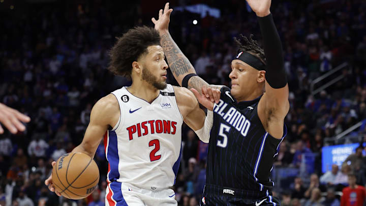 Oct 19, 2022; Detroit, Michigan, USA;  Detroit Pistons guard Cade Cunningham (2) is defended by Orlando Magic forward Paolo Banchero (5) in the second half at Little Caesars Arena. Mandatory Credit: Rick Osentoski-Imagn Images