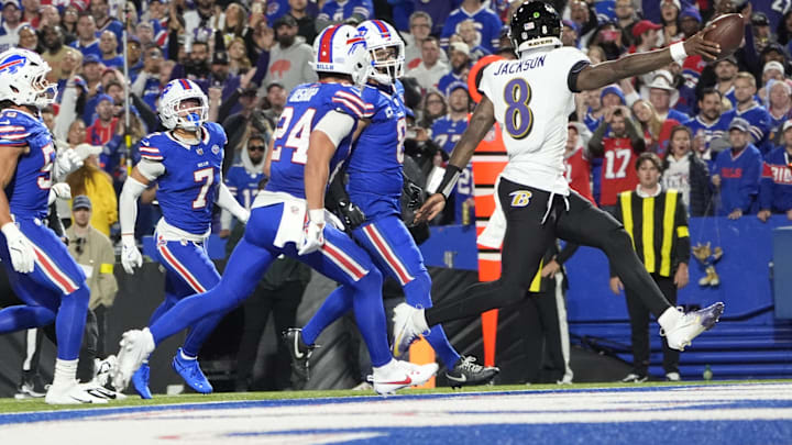 Baltimore Ravens quarterback Lamar Jackson (8) scores a touchdown during the second quarter against the Buffalo Bills at Highmark Stadium.