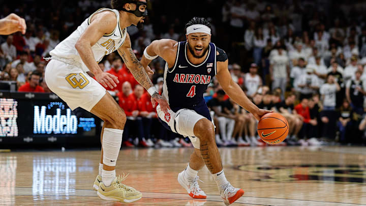 Feb 10, 2024; Boulder, Colorado, USA; Arizona Wildcats guard Kylan Boswell (4) controls the ball against Colorado Buffaloes guard J'Vonne Hadley (1) in the first half at CU Events Center. Mandatory Credit: Isaiah J. Downing-Imagn Images