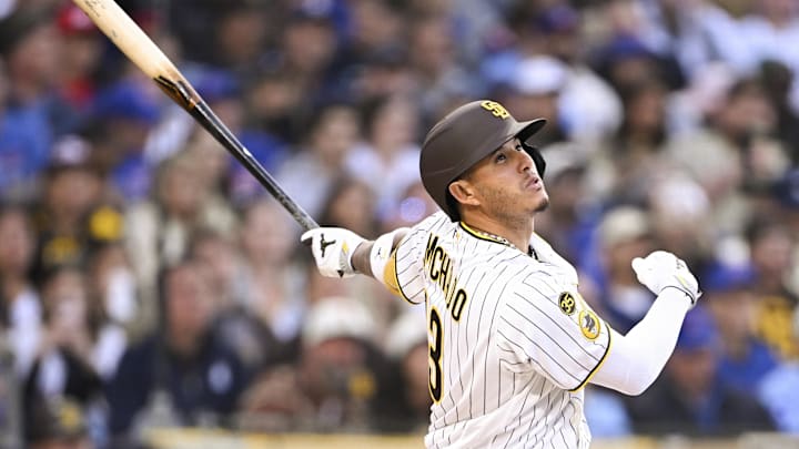 Apr 27, 2026; San Diego, California, USA; San Diego Padres third baseman Manny Machado (13) hits a single during the first inning against the Chicago Cubs at Petco Park. Mandatory Credit: Denis Poroy-Imagn Images