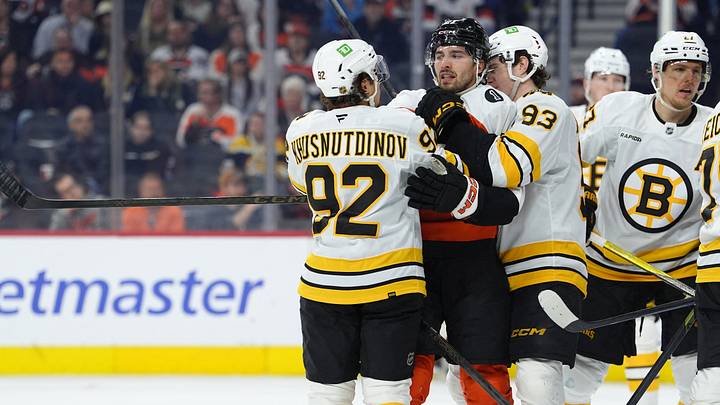 Apr 5, 2026; Philadelphia, Pennsylvania, USA; Philadelphia Flyers left wing Noah Cates (27) grapples with Boston Bruins center Marat Khusnutdinov (92) and center Fraser Minten (93) in the third period at Xfinity Mobile Arena. Mandatory Credit: Kyle Ross-Imagn Images