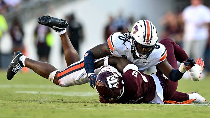 Sep 27, 2025; College Station, Texas, USA; Auburn Tigers linebacker Robert Woodyard Jr. (0) wraps up Texas A&M Aggies running back Le'Veon Moss (8) during the third quarter at Kyle Field. Mandatory Credit: Maria Lysaker-Imagn Images Sep 27, 2025; College Station, Texas, USA; Auburn Tigers linebacker Robert Woodyard Jr. (0) wraps up Texas A&M Aggies running back Le'Veon Moss (8) during the third quarter at Kyle Field. Mandatory Credit: Maria Lysaker-Imagn Images