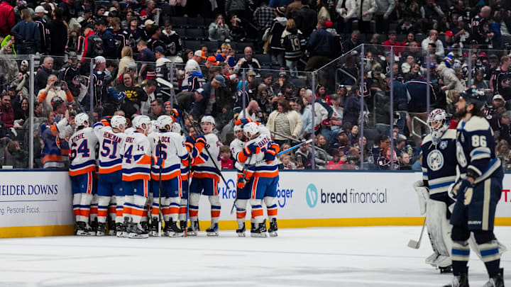 Feb 28, 2026; Columbus, Ohio, USA;  New York Islanders right wing Simon Holmstrom (10) celebrates with teammates after scoring the game-winning goal against the Columbus Blue Jackets in the overtime period at Nationwide Arena. Mandatory Credit: Aaron Doster-Imagn Images