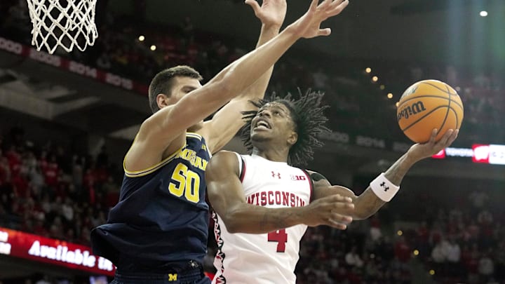 Wisconsin guard Kamari McGee (4) scores on Michigan center Vladislav Goldin (50) 