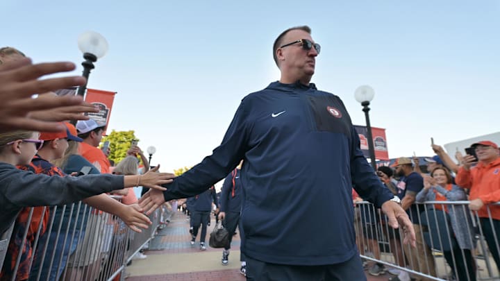Sep 27, 2025; Champaign, Illinois, USA;  Illinois Fighting Illini head coach Bret Bielema leads his team down the Illini Walk before an NCAA football game with the Southern California Trojans at Memorial Stadium. Mandatory Credit: Ron Johnson-Imagn Images
