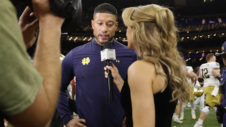 Jan 2, 2025; New Orleans, LA, USA; Notre Dame Fighting Irish head coach Marcus Freeman (center) speaks to the media after defeating the Georgia Bulldogs at Caesars Superdome. Mandatory Credit: Amber Searls-Imagn Images Jan 2, 2025; New Orleans, LA, USA; Notre Dame Fighting Irish head coach Marcus Freeman (center) speaks to the media after defeating the Georgia Bulldogs at Caesars Superdome. Mandatory Credit: Amber Searls-Imagn Images