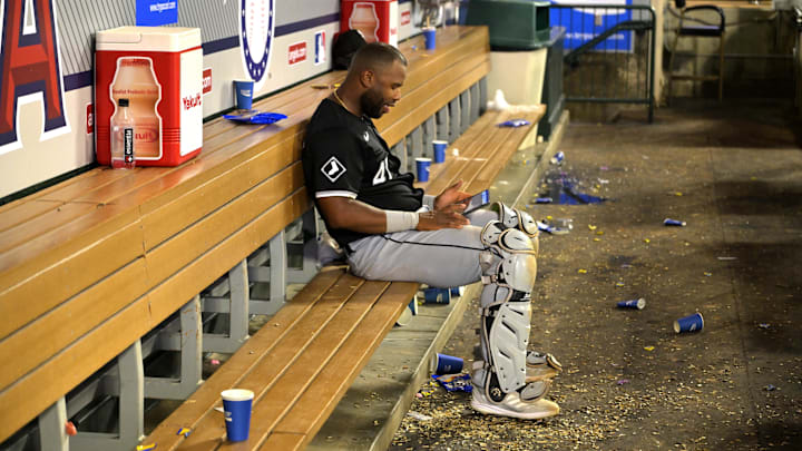 Sep 16, 2024; Anaheim, California, USA; Chicago White Sox catcher Chuckie Robinson (47) sits in an empty dugout reviewing his batting on an iPad after the game against the Los Angeles Angels at Angel Stadium. Mandatory Credit: Jayne Kamin-Oncea-Imagn Images