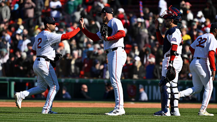 Apr 8, 2026; Boston, Massachusetts, USA; Boston Red Sox relief pitcher Ryan Watson (56) celebrates beating the Milwaukee Brewers with second baseman Isiah Kiner-Falefa (2) at Fenway Park. Mandatory Credit: Eric Canha-Imagn Images
