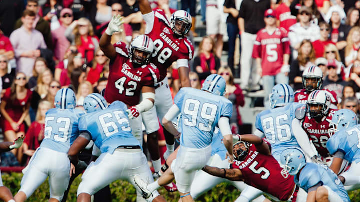 Nov 19, 2011; Columbia, SC, USA; South Carolina Gamecocks defensive tackle Travian Robertson (42) and defensive end Devin Taylor (98) and cornerback Stephon Gilmore (5) attempt to block the field goal attempt of Citadel Bulldogs kicker Ryan Sellers (99) in the first half at Williams-Brice Stadium. Mandatory Credit: Jeff Blake-Imagn Images