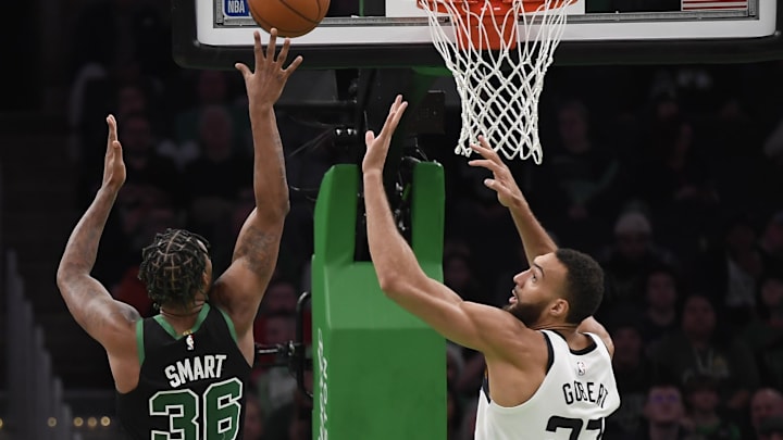 Dec 23, 2022; Boston, Massachusetts, USA; Boston Celtics guard Marcus Smart (36) shoots the ball over Minnesota Timberwolves center Rudy Gobert (27) during the second half at TD Garden. Mandatory Credit: Bob DeChiara-Imagn Images