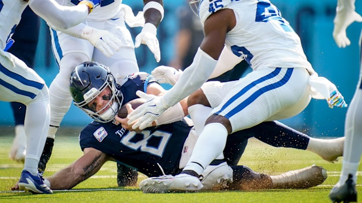 Tennessee Titans quarterback Will Levis (8) collides with Indianapolis Colts linebacker E.J. Speed (45) during the second quarter at Nissan Stadium in Nashville, Tenn., Sunday, Oct. 13, 2024.