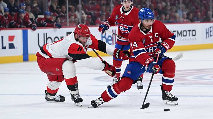 May 27, 2026; Montreal, Quebec, CAN; Montreal Canadiens center Nick Suzuki (14) skates past Carolina Hurricanes center Jordan Staal (11) during the first period in game four of the Eastern Conference Final of the 2026 Stanley Cup Playoffs at Bell Centre. Mandatory Credit: David Kirouac-Imagn Images