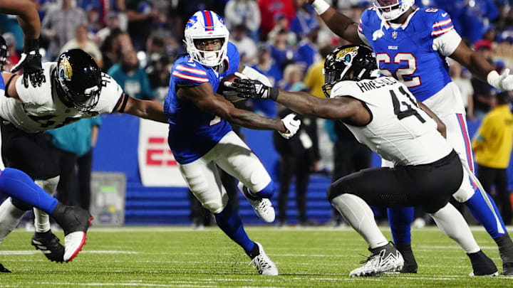 Sep 23, 2024; Orchard Park, New York, USA; Buffalo Bills wide receiver Curtis Samuel (1) runs with the ball against Jacksonville Jaguars defensive end Josh Hines-Allen (41) and Jacksonville Jaguars linebacker Chad Muma (48) during the second half at Highmark Stadium
