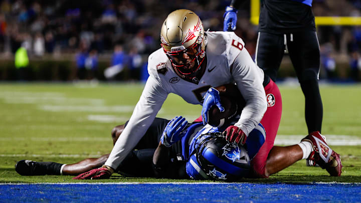 Oct 18, 2024; Durham, North Carolina, USA; Duke Blue Devils quarterback Maalik Murphy (6) attempts to run the ball to the end zone but is tacked by Florida State Seminoles defensive lineman Darrell Jackson Jr. (6) during the first half of the game at Wallace Wade Stadium. Mandatory Credit: Jaylynn Nash-Imagn Images