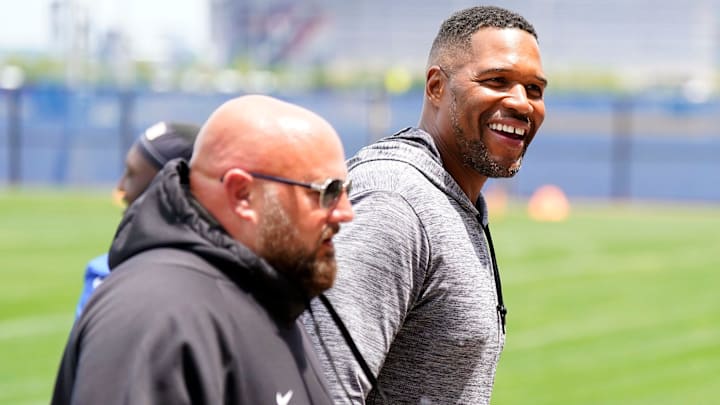 Former New York Giants defensive end Michael Strahan, right, and head coach Brian Daboll walk off the field after the first day of mandatory minicamp at the Giants training center in East Rutherford on Tuesday, June 13, 2023.