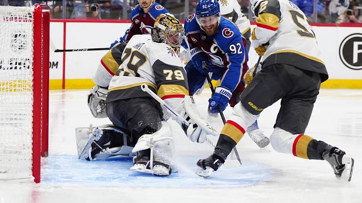 May 22, 2026; Denver, Colorado, USA; Colorado Avalanche left wing Gabriel Landeskog (92), Vegas Golden Knights defenseman Dylan Coghlan (52) and goaltender Carter Hart (79) battle for control of the puck during the second period of game two of the Western Conference Final of the 2026 Stanley Cup Playoffs at Ball Arena. Mandatory Credit: Ron Chenoy-Imagn Images