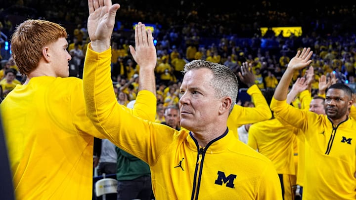 Michigan head coach Dusty May high-fives players and coaches after 90-80 win over Michigan State at Crisler Center in Ann Arbor on Sunday, March 8, 2026.