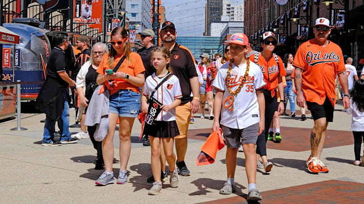Mar 31, 2025; Baltimore, Maryland, USA; Baltimore Orioles fans walk around prior to the opening home game against the Boston Red Sox at Oriole Park at Camden Yards.