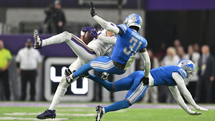 Dec 24, 2023; Minneapolis, Minnesota, USA; Minnesota Vikings wide receiver Justin Jefferson (18) makes a leaping catch in front of Detroit Lions safety Kerby Joseph (31) and cornerback Cameron Sutton (1) during the fourth quarter at U.S. Bank Stadium.