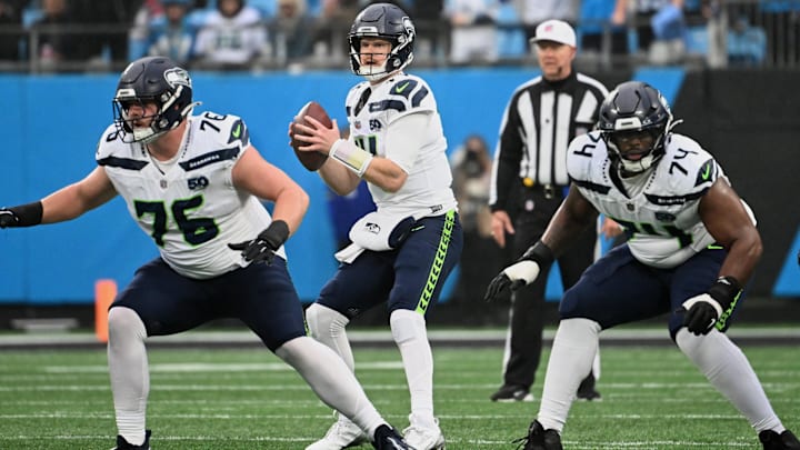 Seattle Seahawks quarterback Sam Darnold (14) looks to throw a pass as guards Grey Zabel (76) and Josh Jones (74) block. Seattle Seahawks quarterback Sam Darnold (14) looks to throw a pass as guards Grey Zabel (76) and Josh Jones (74) block.