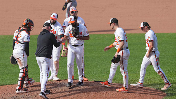 Sep 19, 2024; Baltimore, Maryland, USA; Baltimore Orioles manager Brandon Hyde (left) removes pitcher Seranthony DomÌnguez (center) from the game in the ninth inning against the San Francisco Giants at Oriole Park at Camden Yards.