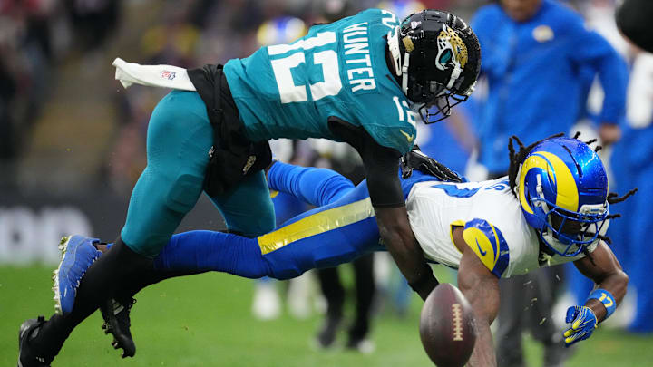 Oct 19, 2025; London, United Kingdom; Los Angeles Rams wide receiver Davante Adams (17) is unable to make a catch while defended by Jacksonville Jaguars wide receiver Travis Hunter (12) during the second half of an NFL International Series game at Wembley Stadium. Mandatory Credit: Kirby Lee-Imagn Images