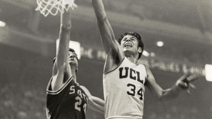 Mar 23, 1974; Greensboro, NC, USA; FILE PHOTO; UCLA Bruins guard Dave Meyers (34) in action against North Carolina State Wolfpack center Tommy Burleson (24) during the 1974 Final Four. NC State beat UCLA 80-77. Mandatory Credit: Malcolm Emmons-Imagn Images Mar 23, 1974; Greensboro, NC, USA; FILE PHOTO; UCLA Bruins guard Dave Meyers (34) in action against North Carolina State Wolfpack center Tommy Burleson (24) during the 1974 Final Four. NC State beat UCLA 80-77. Mandatory Credit: Malcolm Emmons-Imagn Images