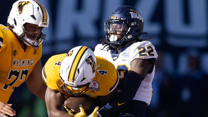 Dec 30, 2023; Tucson, AZ, USA; Toledo Rockets safety Emmanuel McNeil-Warren (22) tackles Wyoming Cowboys running back Harrison Waylee (4) in the Arizona Bowl at Arizona Stadium. Mandatory Credit: Mark J. Rebilas-USA TODAY Sports Dec 30, 2023; Tucson, AZ, USA; Toledo Rockets safety Emmanuel McNeil-Warren (22) tackles Wyoming Cowboys running back Harrison Waylee (4) in the Arizona Bowl at Arizona Stadium. Mandatory Credit: Mark J. Rebilas-USA TODAY Sports