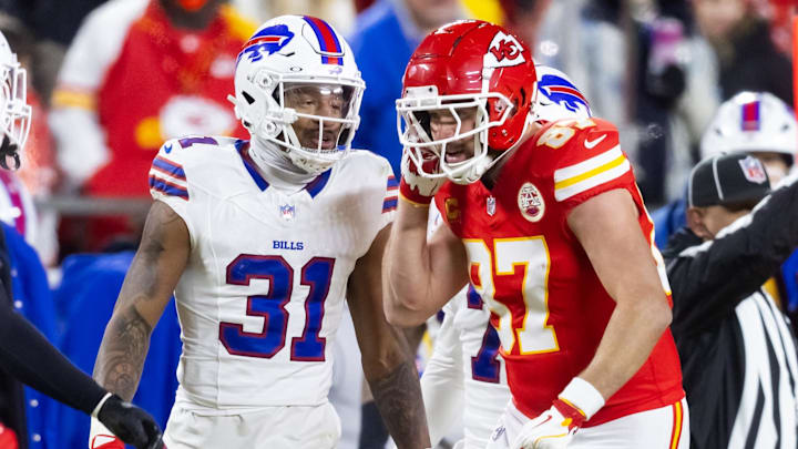 Kansas City Chiefs tight end Travis Kelce (87) reacts as he talks to Buffalo Bills cornerback Rasul Douglas (31) during the AFC Championship game at GEHA Field at Arrowhead Stadium.