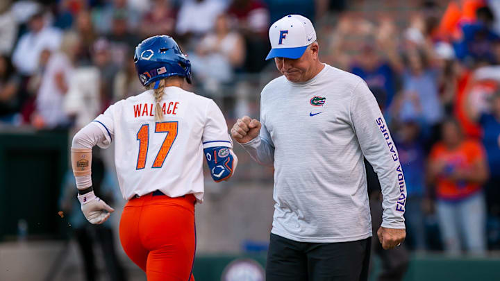 Florida Gators infielder Skylar Wallace (17) gets a fist bump from Head Coach Tim Walton after she