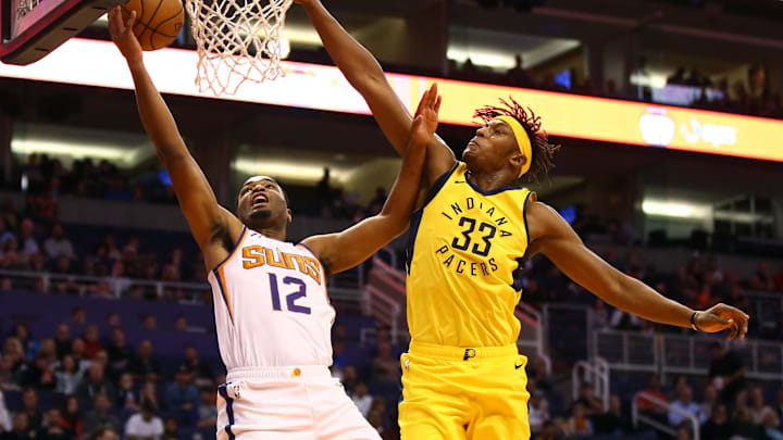 Nov 27, 2018; Phoenix, AZ, USA; Phoenix Suns forward TJ Warren (12) drives to the basket against Indiana Pacers center Myles Turner in the first half at Talking Stick Resort Arena. Mandatory Credit: Mark J. Rebilas-Imagn Images