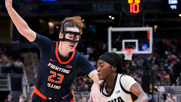 Illinois Fighting Illini forward Berry Wallace (23) guards Iowa Hawkeyes guard Chazadi Wright (11) on Friday, March 6, 2026, during a Big Ten women's basketball tournament game at Gainbridge Fieldhouse in Indianapolis. The Iowa Hawkeyes defeated the Illinois Fighting Illini, 64-58.