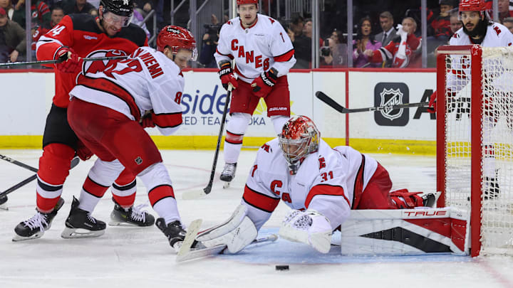 Apr 25, 2025; Newark, New Jersey, USA; Carolina Hurricanes goaltender Frederik Andersen (31) makes a save against the New Jersey Devils during the first overtime in game three of the first round of the 2025 Stanley Cup Playoffs at Prudential Center. Mandatory Credit: Ed Mulholland-Imagn Images