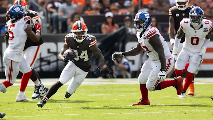 Sep 22, 2024; Cleveland, Ohio, USA; Cleveland Browns running back Jerome Ford (34) runs the ball through a gap in the New York Giants defense during the third quarter at Huntington Bank Field. Mandatory Credit: Scott Galvin-Imagn Images